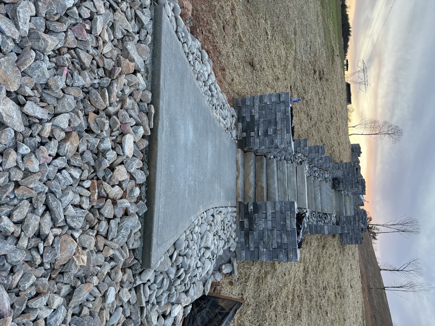 Paver walkway with stone steps and river rock drainage borders North Georgia — new construction hardscape by Kaizen Scapes
