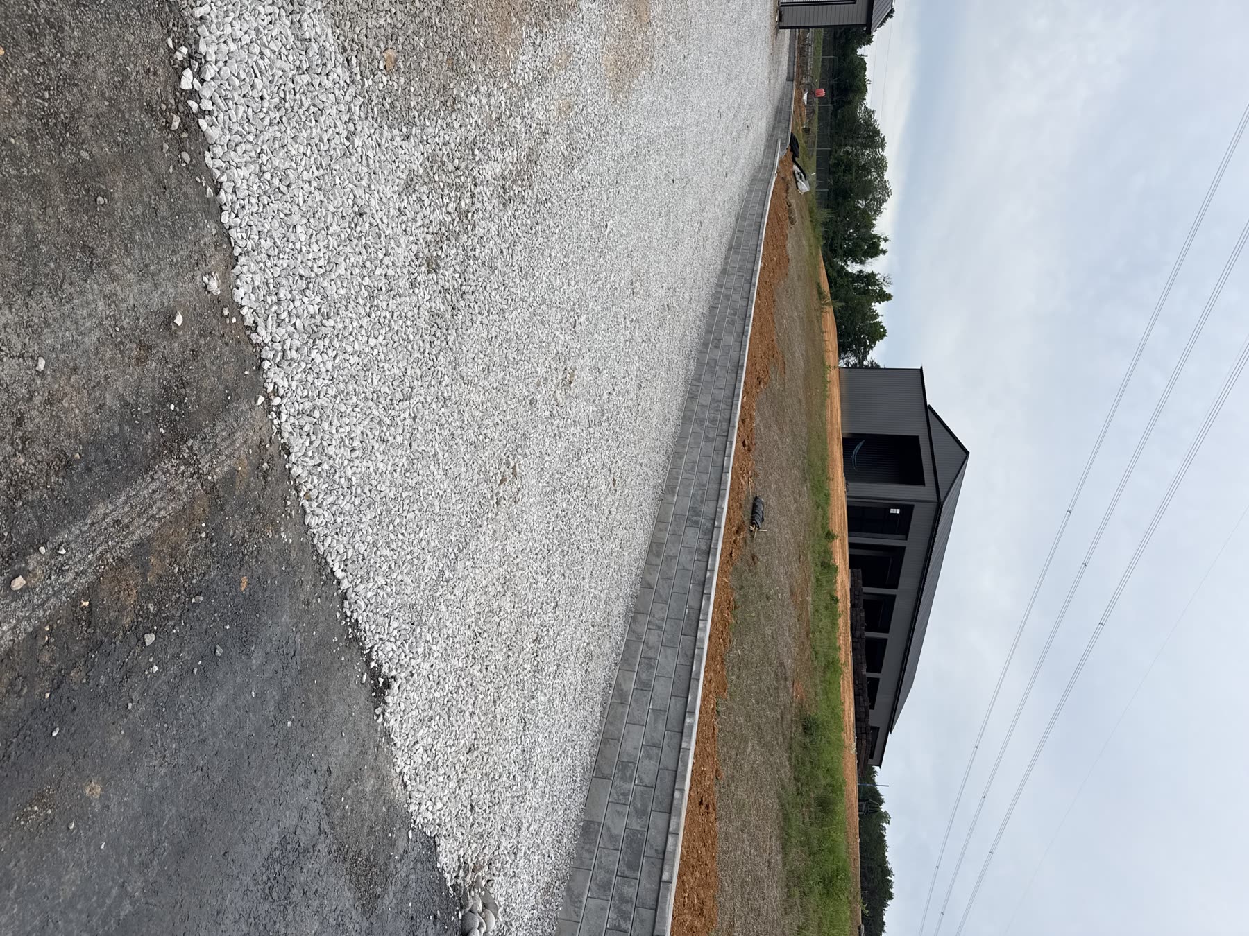 New construction driveway approach with paver border and gravel base North Georgia — hardscape by Kaizen Scapes